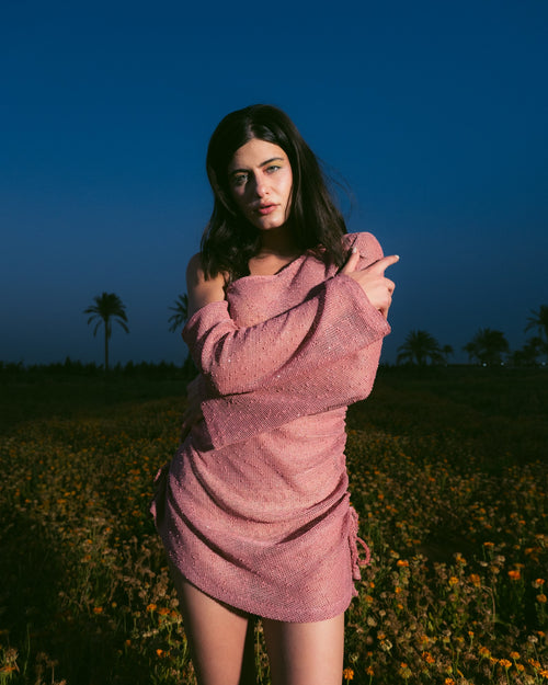 A feminine off-shoulder dress crafted for sunny beach days and summer getaways. Features a flowing silhouette and soft pink shade for an effortlessly elegant look.